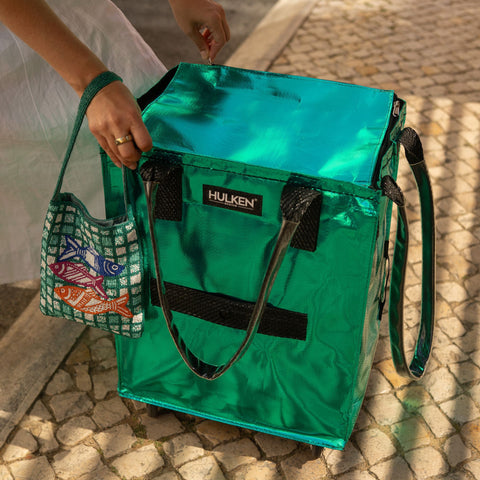 Teal rolling tote on a ground