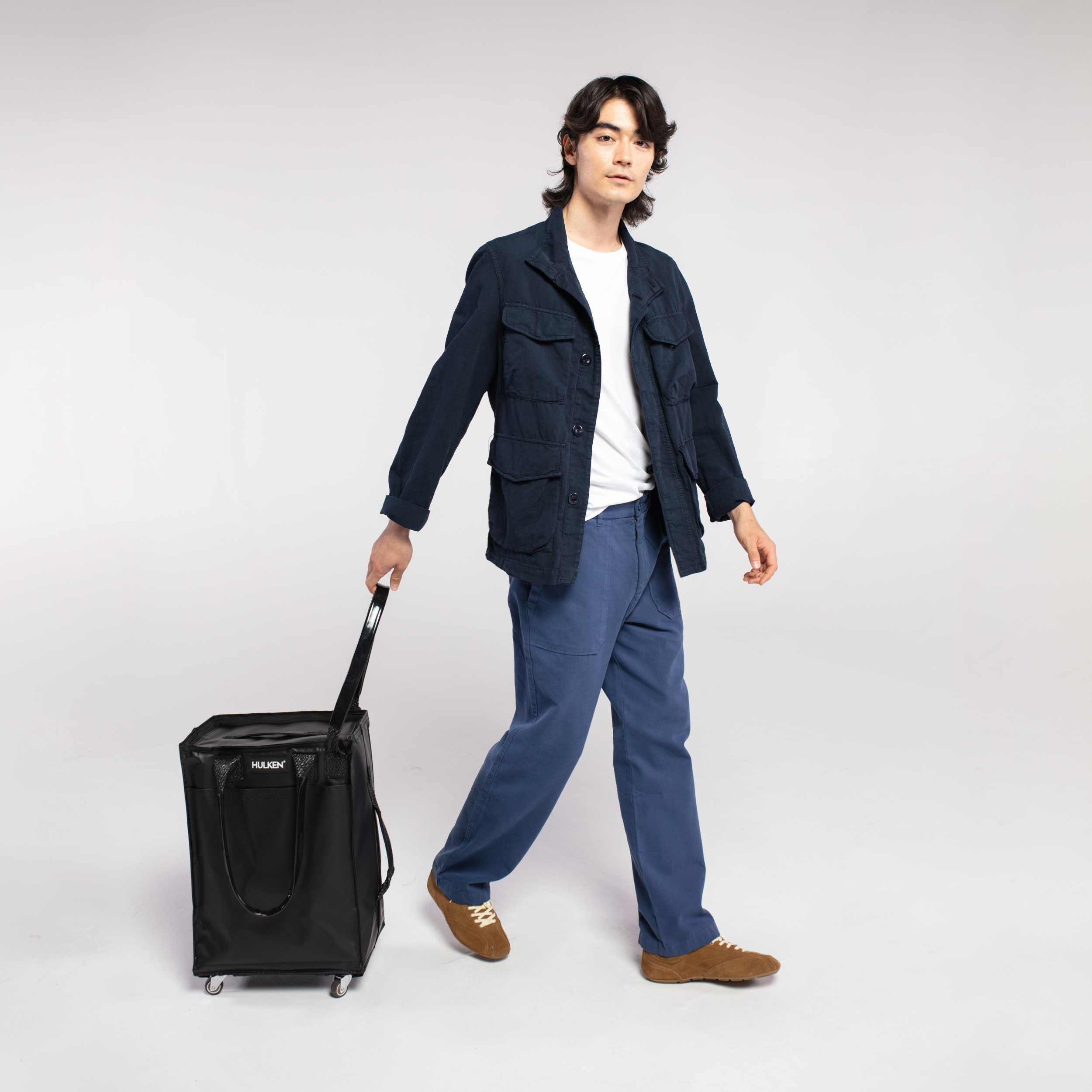 Person holding a black carry-on